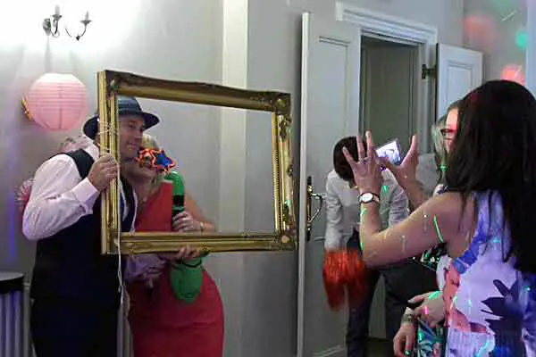 A group of wedding guests holding the photo selfie frame